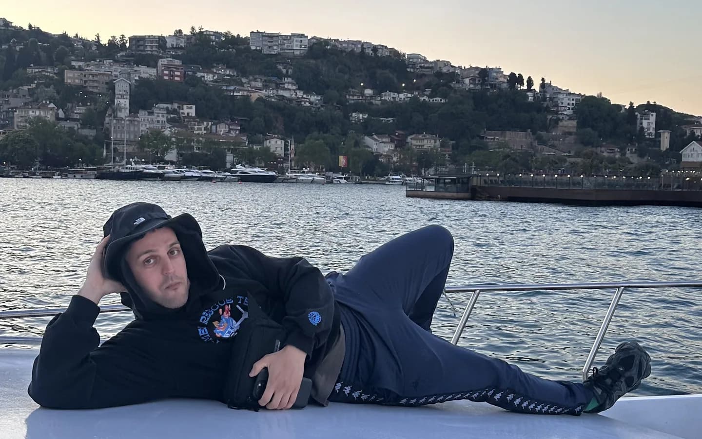 Private yacht sailing on the Bosphorus in Istanbul at golden hour with Ottoman palaces in the background