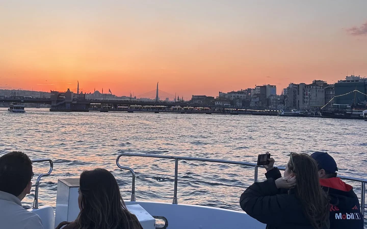 Elegant dinner table on a Bosphorus cruise boat with illuminated Istanbul skyline at night