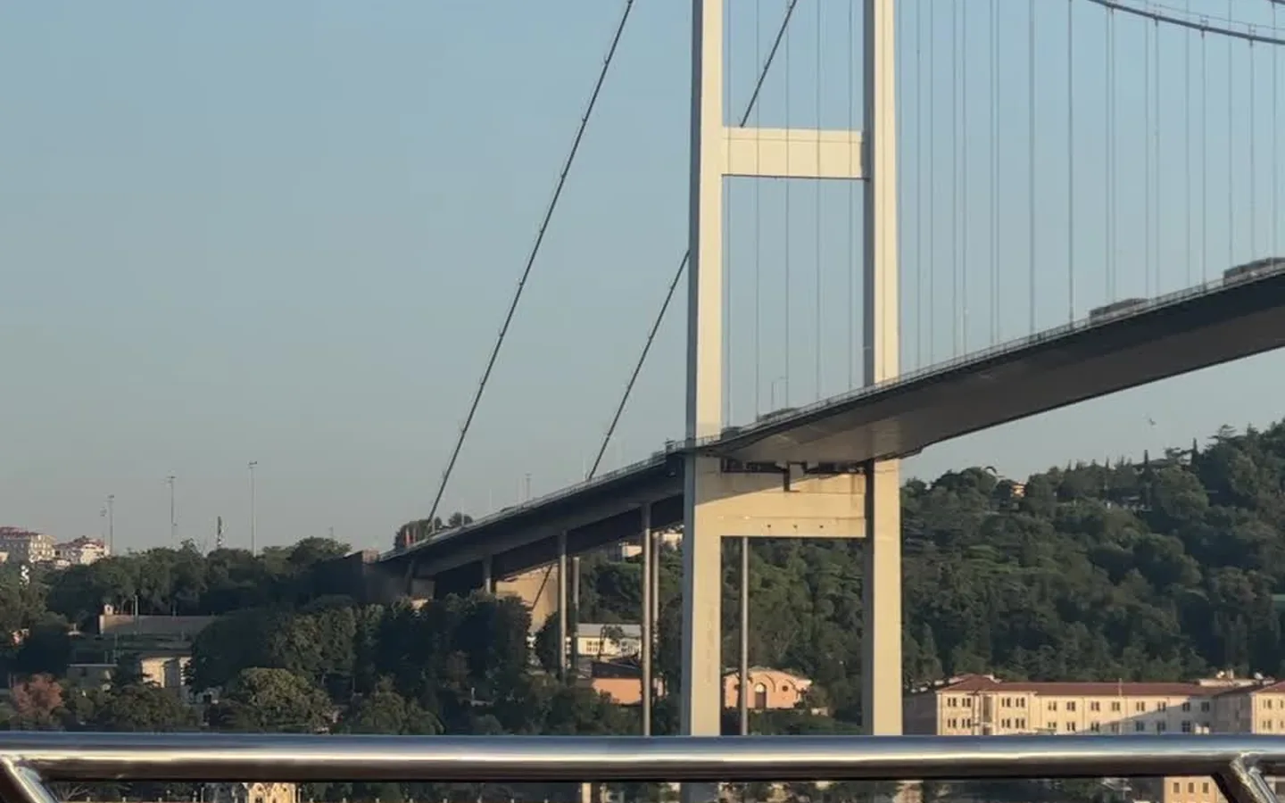 Side-by-side view of a tour boat with guide and a public Istanbul ferry on the Bosphorus
