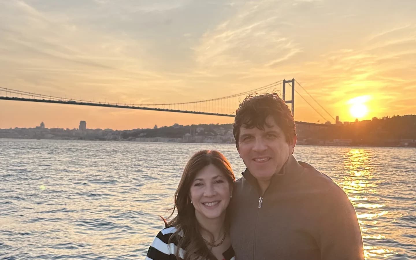 Guests enjoying a Bosphorus cruise in Istanbul with scenic views of Ottoman palaces and the Bosphorus Bridge