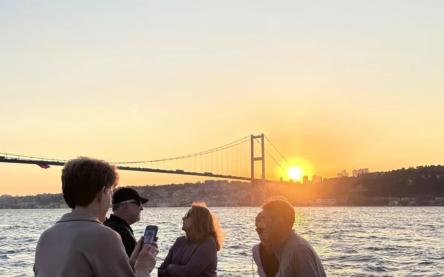 Multiple cruise boats on the Bosphorus strait in Istanbul with historic skyline in the background