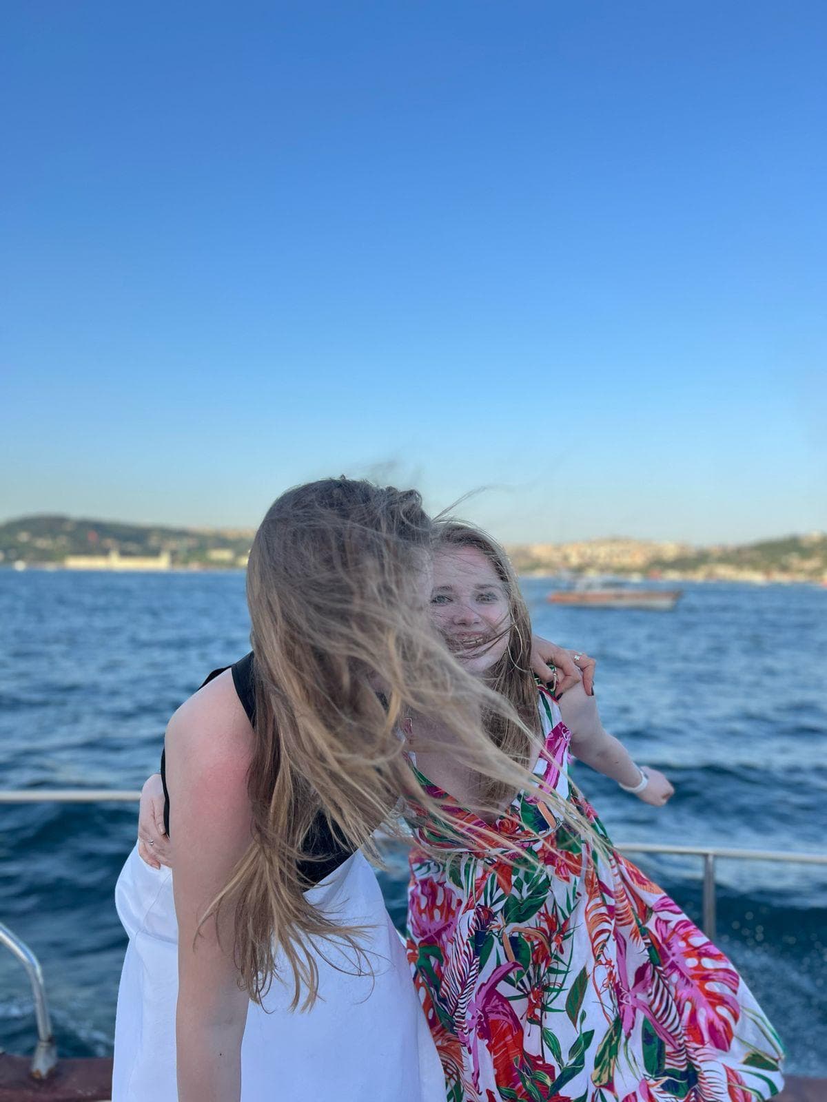 Large group celebrating on a private boat on the Bosphorus in Istanbul with the Bosphorus Bridge in the background