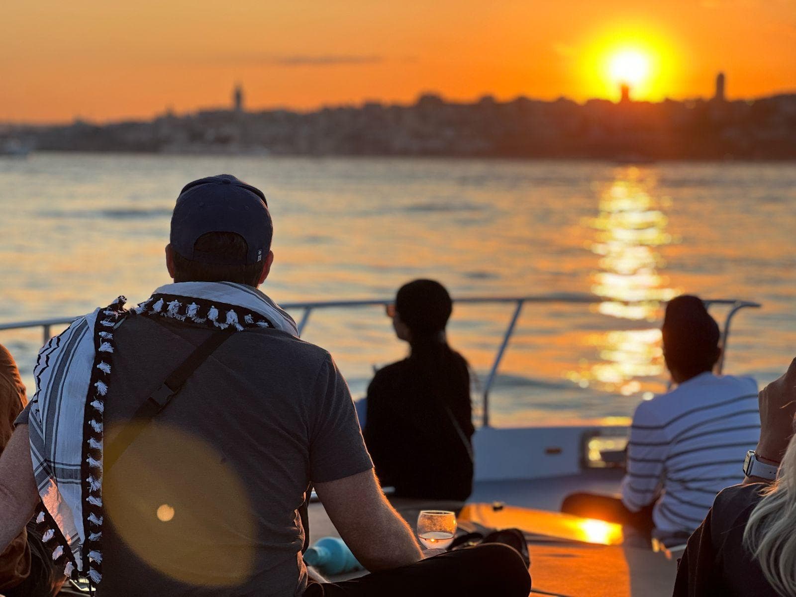 Bosphorus cruise boat departing from Kabataş pier at golden hour with Istanbul skyline